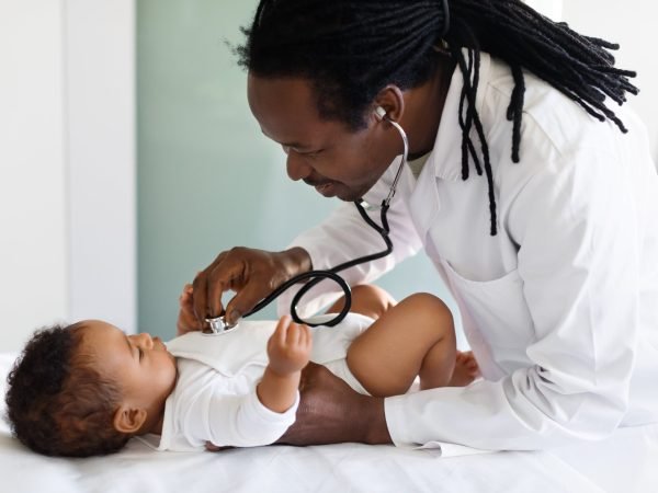 pediatrician-doctor-making-check-up-with-cute-blac-2023-11-27-05-13-27-utc-min
